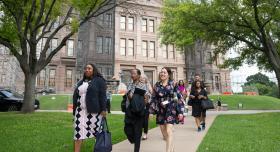 L to R, front to back: LBJWCS Cohort 5 Members Francesca Francois Haas, Vanessa Johnson, Dalia Zamora, Cathy McHorse, Alexandria Andersen, Regina Cochran, and Christopher Ludiker stroll out of the Texas State Capitol after Day One of training. 