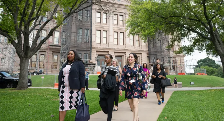 L to R, front to back: LBJWCS Cohort 5 Members Francesca Francois Haas, Vanessa Johnson, Dalia Zamora, Cathy McHorse, Alexandria Andersen, Regina Cochran, and Christopher Ludiker stroll out of the Texas State Capitol after Day One of training.